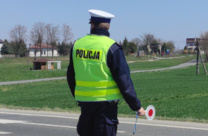 policjant z tarczą do zatrzymywań pojazdów